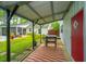 Cozy outdoor patio with a grill, offering a perfect spot for cooking and enjoying the view of the backyard and pool at 229 Twin Lake Dr, Summerville, SC 29483
