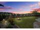 Landscaped backyard featuring a fire pit and a fenced perimeter with illuminated pathway lights at 234 Basket Grass Ln, Summerville, SC 29486