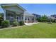 Spacious backyard with lush green grass, patio seating, a hot tub, and well-maintained landscaping at 234 Basket Grass Ln, Summerville, SC 29486