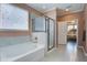 Bright bathroom showcasing separate tub and shower; door leads to bedroom at 234 Basket Grass Ln, Summerville, SC 29486