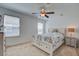 Bright bedroom featuring windows with white trim and ceiling fan at 234 Basket Grass Ln, Summerville, SC 29486