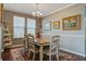 Cozy dining room with a wooden table, comfortable chairs, and natural light from the windows at 234 Basket Grass Ln, Summerville, SC 29486