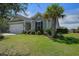 Charming single-story home with a well-manicured lawn and a mature palm tree in the front yard at 234 Basket Grass Ln, Summerville, SC 29486