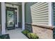 Inviting front porch with white columns and brick accents leading to a modern front door at 234 Basket Grass Ln, Summerville, SC 29486