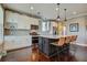 Well-equipped kitchen with white cabinets, granite countertops, a dark island with seating, and modern appliances at 234 Basket Grass Ln, Summerville, SC 29486