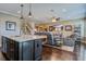 Open floor plan with kitchen island flowing into a living area with hardwood floors and natural lighting at 234 Basket Grass Ln, Summerville, SC 29486