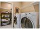 Well-equipped laundry room with shelving, a washboard, and modern washer and dryer at 234 Basket Grass Ln, Summerville, SC 29486