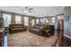 Open-concept living room featuring two sofas, hardwood floors, and seamless transition to the kitchen at 234 Basket Grass Ln, Summerville, SC 29486