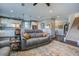 Spacious living room with dark hardwood floors, a gray sofa, and open access to the kitchen and dining area at 234 Basket Grass Ln, Summerville, SC 29486