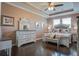 Elegant main bedroom featuring tray ceilings, hardwood floors, and a coordinated furniture set at 234 Basket Grass Ln, Summerville, SC 29486