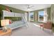Charming bedroom featuring a bunk bed, green walls, and bright natural light from two windows at 238 Silk Oak Dr, Moncks Corner, SC 29461