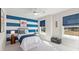 Charming bedroom with blue and white striped walls, a cozy bed, and bright natural light at 238 Silk Oak Dr, Moncks Corner, SC 29461