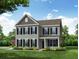 Charming two-story home with gray siding, black shutters, and a well-manicured lawn at 238 Silk Oak Dr, Moncks Corner, SC 29461