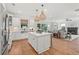 Modern kitchen with stainless steel appliances, white cabinetry, a central island, and hardwood floors at 238 Silk Oak Dr, Moncks Corner, SC 29461