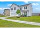 Beautiful two-story home featuring a manicured lawn and an attached two-car garage at 306 Lucca Dr, Summerville, SC 29486