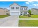 Charming two-story home with a well-manicured lawn, attached garage, and classic white siding at 306 Lucca Dr, Summerville, SC 29486