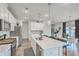 Spacious kitchen island with quartz countertops, stainless steel appliances, and modern pendant lighting at 306 Lucca Dr, Summerville, SC 29486