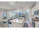 Open kitchen and living area with a large island, stainless appliances, and hardwood floors at 306 Lucca Dr, Summerville, SC 29486