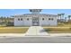A lovely white pool house with a gray metal roof and a gated entryway leading to the pool at 306 Lucca Dr, Summerville, SC 29486