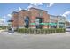 Starbucks storefront featuring a brick facade, outdoor seating with green umbrellas, and convenient drive-thru access at 306 Lucca Dr, Summerville, SC 29486