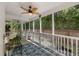 Covered porch with ceiling fan overlooking a lush green backyard with privacy fence at 3121 Harding Ct, Johns Island, SC 29455