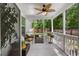 Relaxing screened porch with wicker furniture, ceiling fan, and view of the landscaped backyard at 3121 Harding Ct, Johns Island, SC 29455