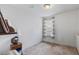 Well-lit bedroom with neutral carpet, a window with blinds, and decorative shelf and nightstand at 3121 Harding Ct, Johns Island, SC 29455