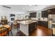 Open-concept kitchen with a large island, stainless steel appliances, and dark cabinetry at 3121 Harding Ct, Johns Island, SC 29455
