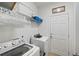 Clean laundry room with washer, dryer, storage shelves, and a door to the backyard at 3121 Harding Ct, Johns Island, SC 29455