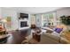 Bright living room features a fireplace, large windows, and comfortable seating area at 3121 Harding Ct, Johns Island, SC 29455