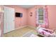 Bright pink bedroom with twin beds, TV, and colorful Hello Kitty themed decor at 317 Dorchester Manor Blvd, North Charleston, SC 29420