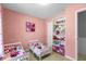 Pink-themed bedroom featuring twin beds, playful decor, and organized shelving with toys at 317 Dorchester Manor Blvd, North Charleston, SC 29420