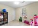 Neutral-toned bedroom with toys, tiled floor, natural light, and a closet for organized storage at 317 Dorchester Manor Blvd, North Charleston, SC 29420