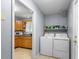 Functional laundry room with a washer, dryer, and storage shelving near the kitchen at 317 Dorchester Manor Blvd, North Charleston, SC 29420
