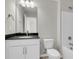 Bright bathroom featuring a vanity with a black countertop and a white toilet and shower at 319 Abercom Place Dr, Moncks Corner, SC 29461