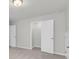 Bedroom with neutral carpet and paint, features an open closet and access doors at 319 Abercom Place Dr, Moncks Corner, SC 29461