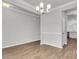 Bright, open dining room with wood floors, elegant lighting and access to kitchen at 319 Abercom Place Dr, Moncks Corner, SC 29461