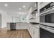 Spacious open kitchen with white cabinets, island, and stainless steel appliances at 319 Abercom Place Dr, Moncks Corner, SC 29461