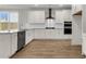 Modern kitchen with white cabinets, stainless steel appliances, and granite countertops at 319 Abercom Place Dr, Moncks Corner, SC 29461