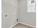 Functional laundry room with tiled floors, storage shelving, and washer/dryer hookups at 319 Abercom Place Dr, Moncks Corner, SC 29461