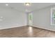 Bright living room with access to outdoor patio and features hardwood floors at 319 Abercom Place Dr, Moncks Corner, SC 29461