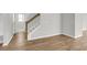 Stairway with wood banister, wood-look floors and neutral walls leading to the upper level at 319 Abercom Place Dr, Moncks Corner, SC 29461