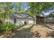 View of the home's backyard with lawn, patio, and a sunroom addition at 335 Macgregor Dr, Summerville, SC 29486