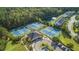 Aerial view of tennis courts, clubhouse, and a pond in a leafy community with townhouses and parking at 3367 Eastman Dr, Mount Pleasant, SC 29466