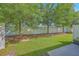 Backyard featuring green grass, a white fence, and mature shade trees at 3367 Eastman Dr, Mount Pleasant, SC 29466