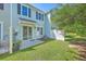 Backyard featuring green grass, a white fence, and a sliding glass door leading to the home's interior at 3367 Eastman Dr, Mount Pleasant, SC 29466