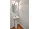 A clean and simple half bathroom with a pedestal sink and wood flooring at 3367 Eastman Dr, Mount Pleasant, SC 29466