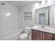 Bright bathroom featuring a shower-tub combo, a mirrored vanity, and a stainless steel shelving unit at 3367 Eastman Dr, Mount Pleasant, SC 29466