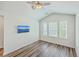 Bedroom with vaulted ceiling, wood-look floors, ceiling fan, and large window for natural light at 3367 Eastman Dr, Mount Pleasant, SC 29466
