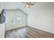 Bedroom with vaulted ceiling, wood-look floors, ceiling fan, and large window for natural light at 3367 Eastman Dr, Mount Pleasant, SC 29466